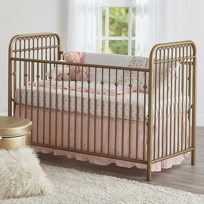 A gold crib is displayed