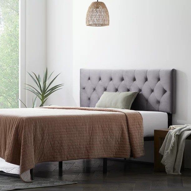 A sleek gray headboard positioned against a bedroom wall, complementing the bed next to it