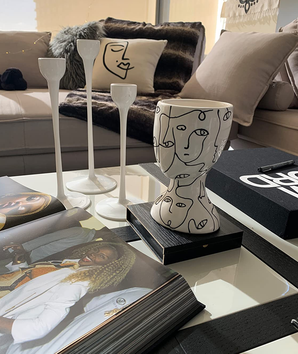 Reviewer photo of a distinctive head-shaped vase placed elegantly on a coffee table.