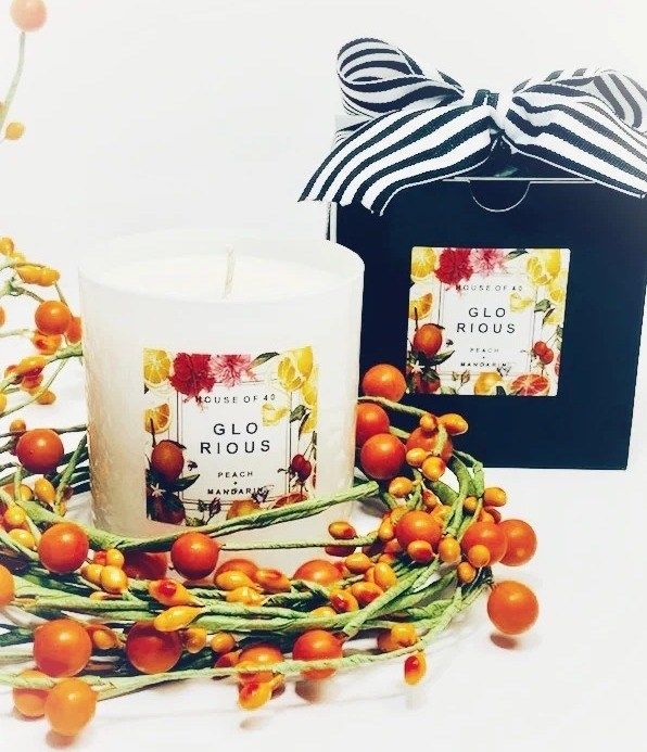 A candle and its packaging are showcased in the image.