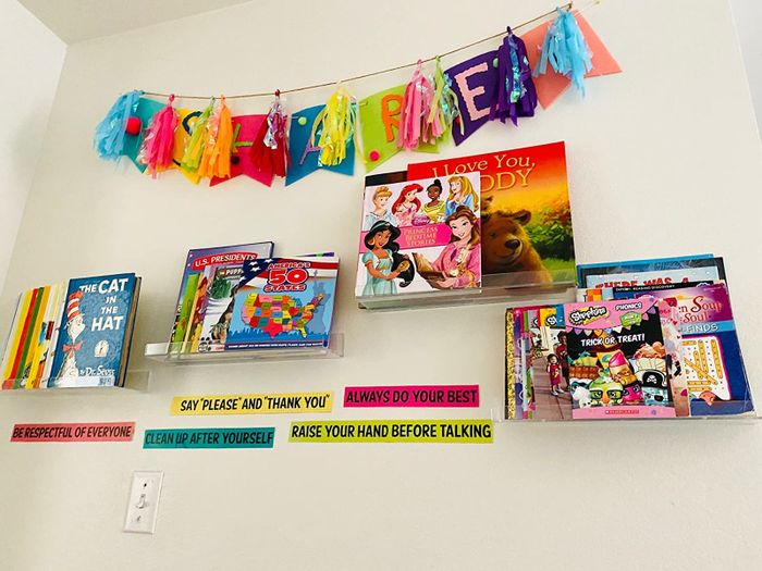 Books are displayed on a wall-mounted shelf