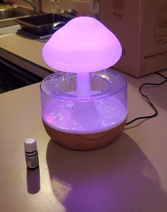 The rain cloud diffuser illuminated in a soft purple light