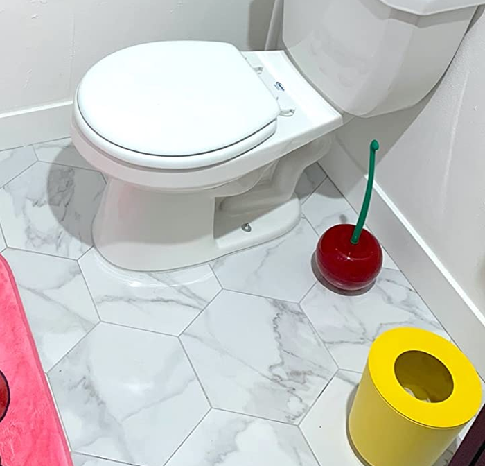The cherry-shaped toilet brush displayed in a reviewer’s bathroom