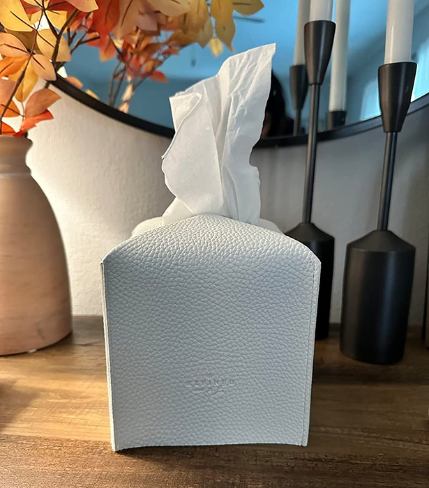 A photo of the white tissue box cover sitting on a table.