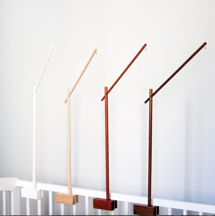 Four mobile holders in various wood finishes are displayed