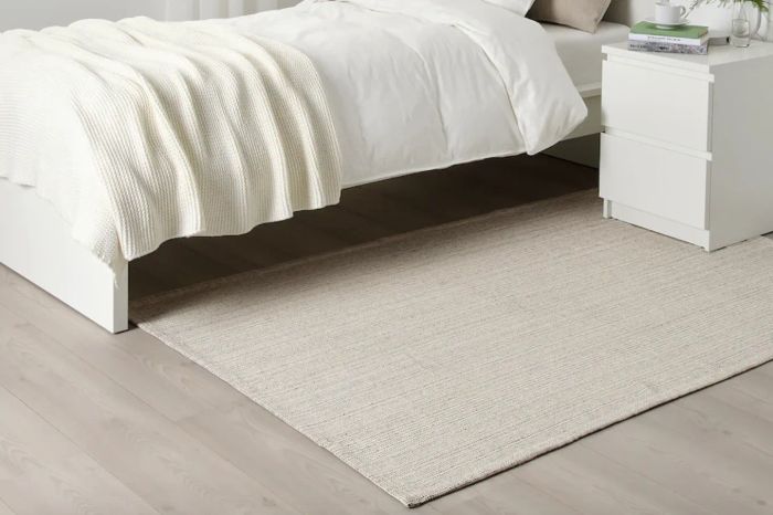 a soft beige rug in a bedroom