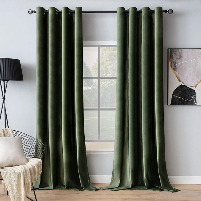 Two blackout curtains partially covering a living room window