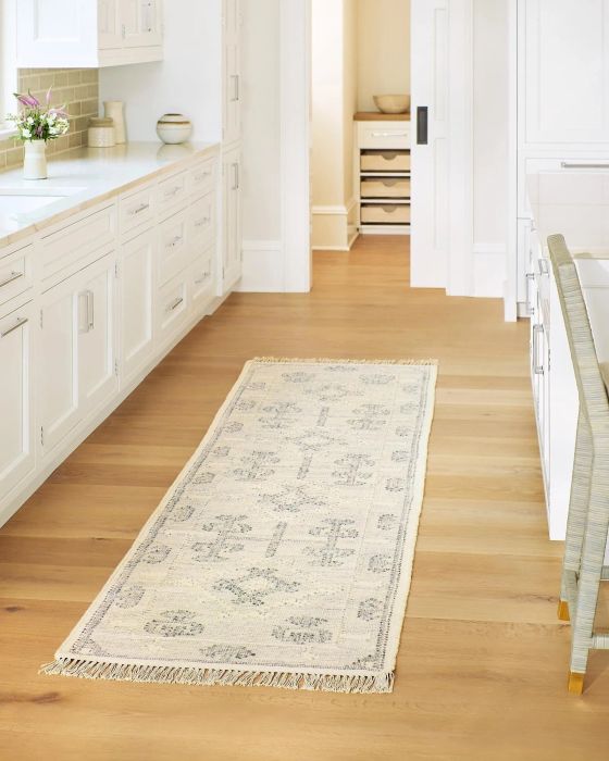 A stylish blue and white runner adorned with fringes, adding a fresh touch of elegance to your hallway or living space.
