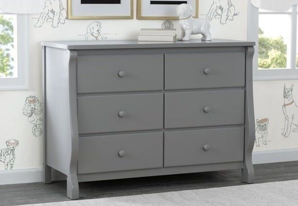 A gray dresser in a child's bedroom