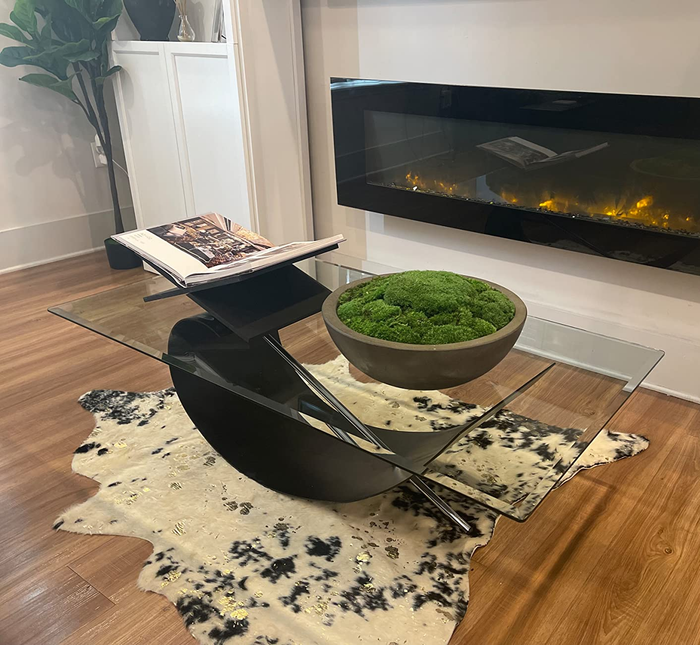 A reviewer’s photo of the black and white rug placed under a coffee table.