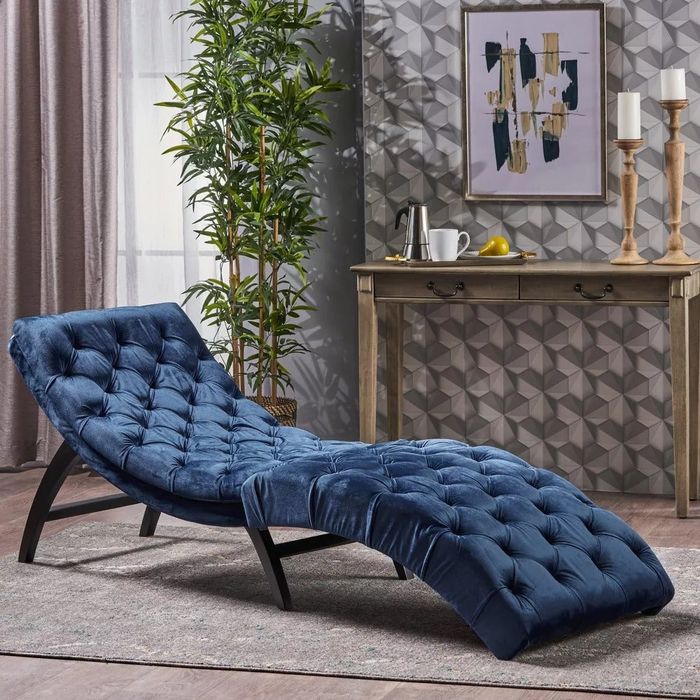 The chaise lounge in a sophisticated dark blue shade.