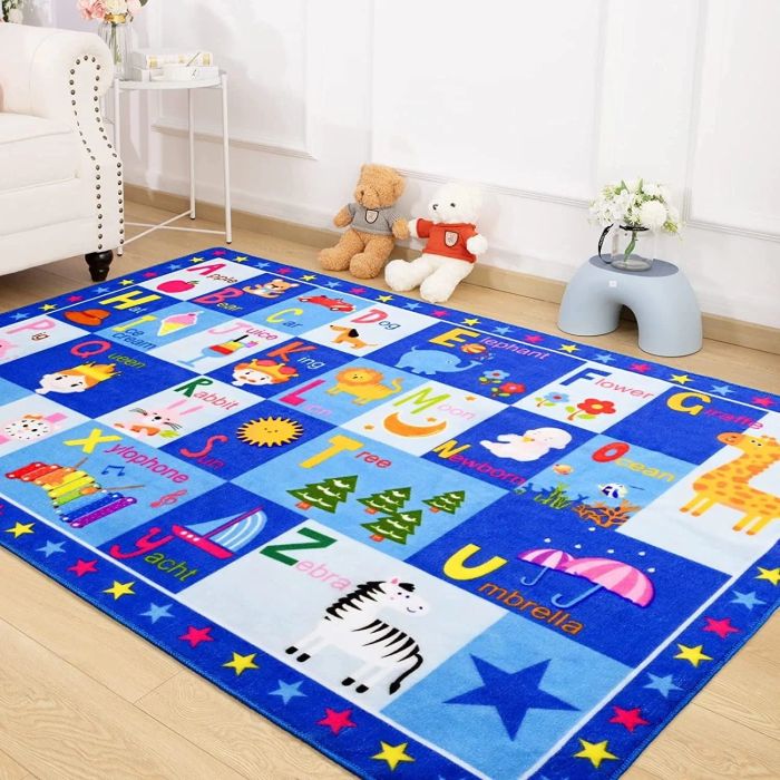 A brightly colored blue alphabet rug in a playroom.