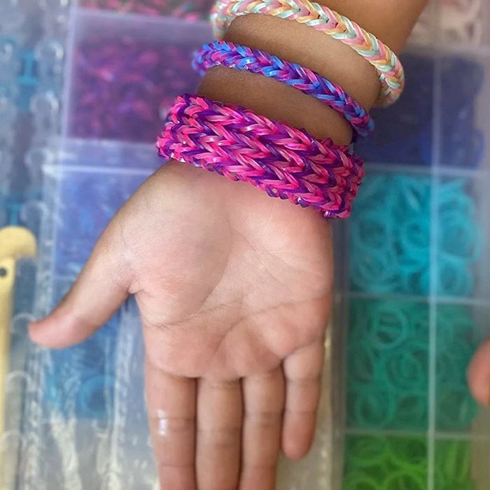 A reviewer’s photo showing a child’s hand and wrist adorned with rubber band bracelets