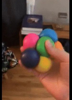 A reviewer throwing the squishy balls at the wall where they stick