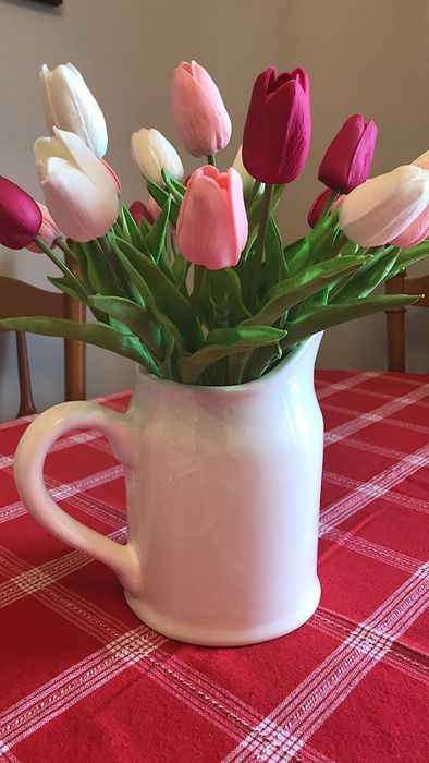 A vase filled with pink and white tulips