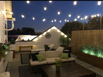 A photo of the same lightbulbs illuminating the space at night
