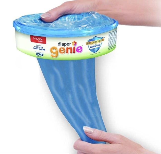 A hand pulling out a Diaper Genie refill bag