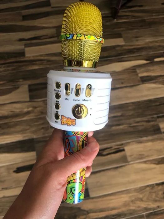 A reviewer's image showing a hand holding a toy microphone