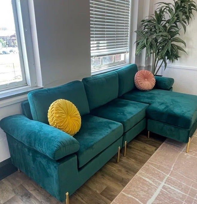 Reviewer photo showcasing a green velvet sofa in a stylish living room