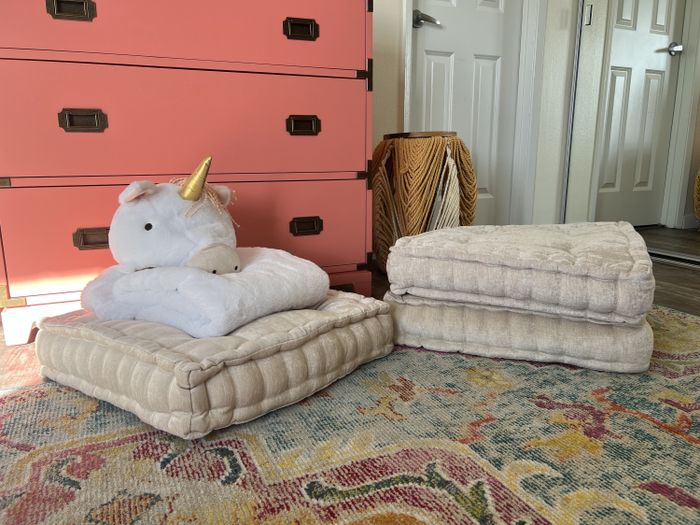 Three floor pillows are shown