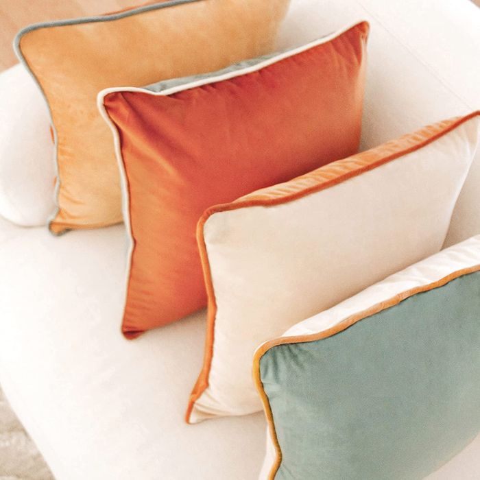 A close-up shot of the same pillow resting on a couch.