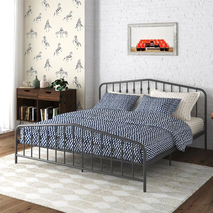 A bed frame set up in a cozy bedroom space