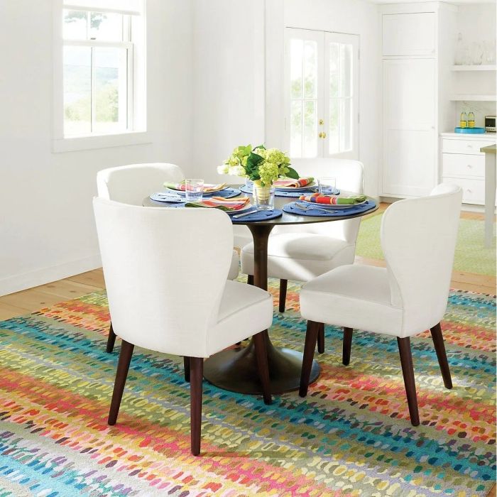 a rainbow-colored hooked wool rug