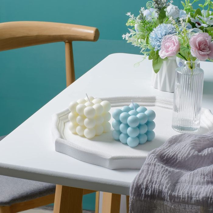 A blue and white candle displayed on a table
