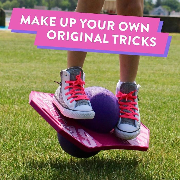 A model's feet on a pink and purple pogo trick ball