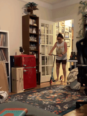 Mytour editor showing off their skills while riding the scooter indoors