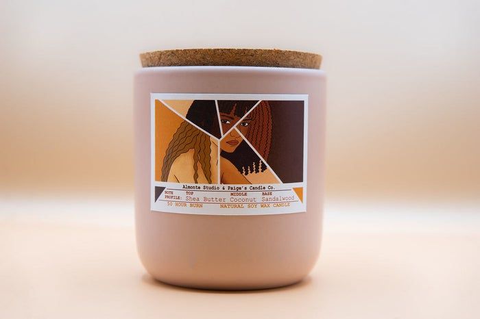 A candle featuring an elegant label is showcased.