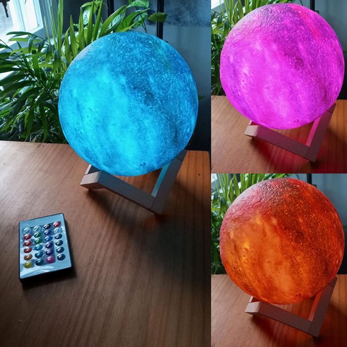 Reviewer's photo of a moon lamp glowing in three vibrant colors