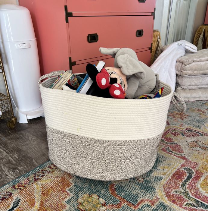 A woven basket filled with toys is displayed