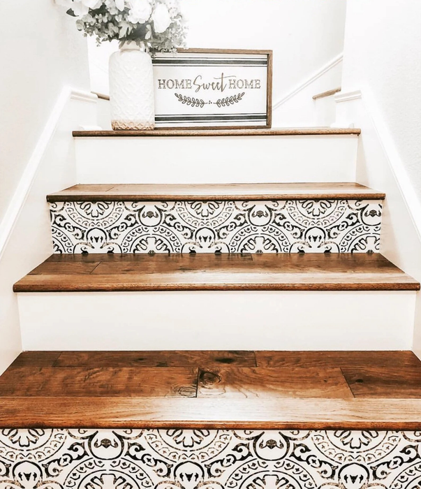 A close-up of the black and white stair decals applied to a staircase, giving it a fresh, modern look.