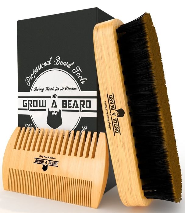 A brush and comb placed next to the beard kit packaging