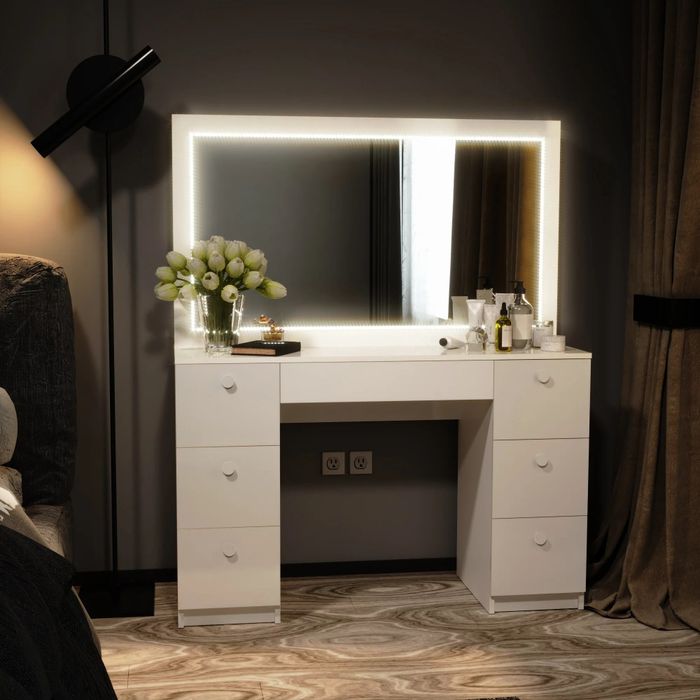 the white vanity in a bedroom with a mirror and storage drawers