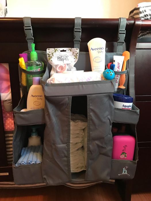 A reviewer’s photo of the organizer hanging on a crib