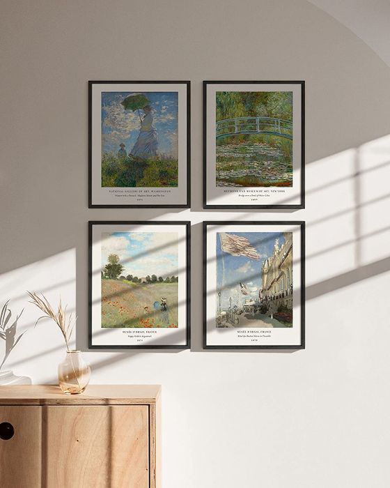 Four framed posters showcasing Monet's artwork displayed on a pristine white wall