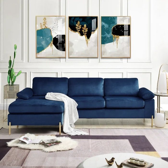 A sophisticated blue velvet sofa elegantly placed in a cozy living space