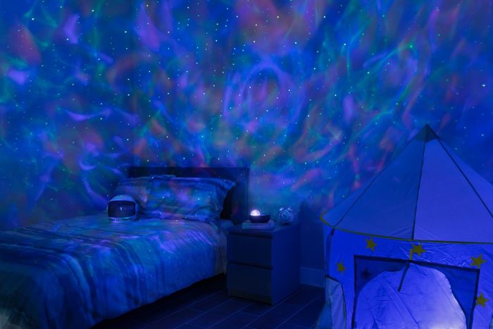 A projector lighting up a bedroom