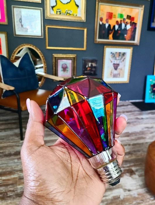 A reviewer excitedly holding the striking diamond-shaped bulb, ready to light up their space.