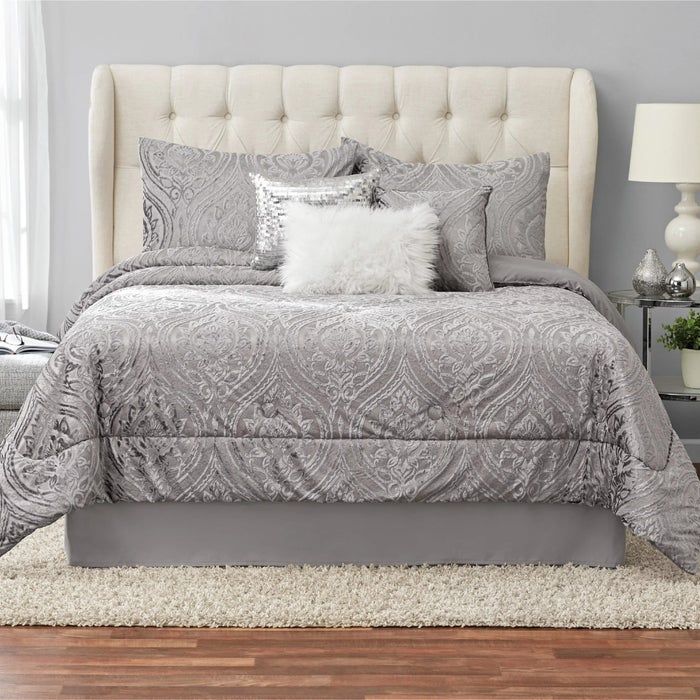 A bedding set arranged on a bed in a bedroom
