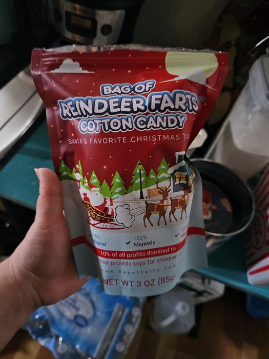 A hand holding a bag of 