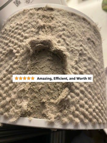 Close-up shot of a heavily dust-covered filter with a five-star review overlay stating
