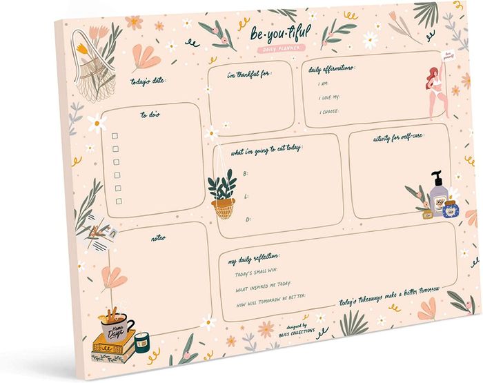A pad of sheets featuring sections for a to-do list, gratitude list, reflections, meal plans, notes, and daily affirmations.