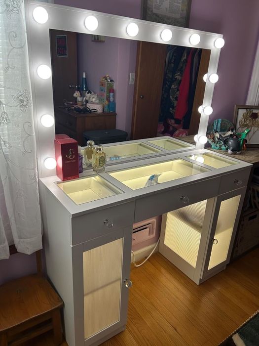 Vanity table with illuminated storage, showcasing beauty products and accessories, perfect for organizing makeup and adding a touch of elegance to your space