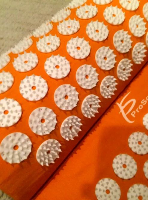 A close-up customer review photo showing the pressure points on the acupressure mat.