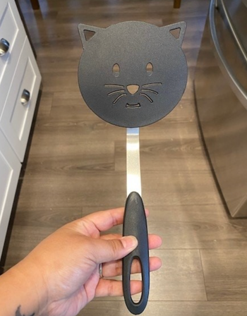 A black spatula shaped like a cat's head