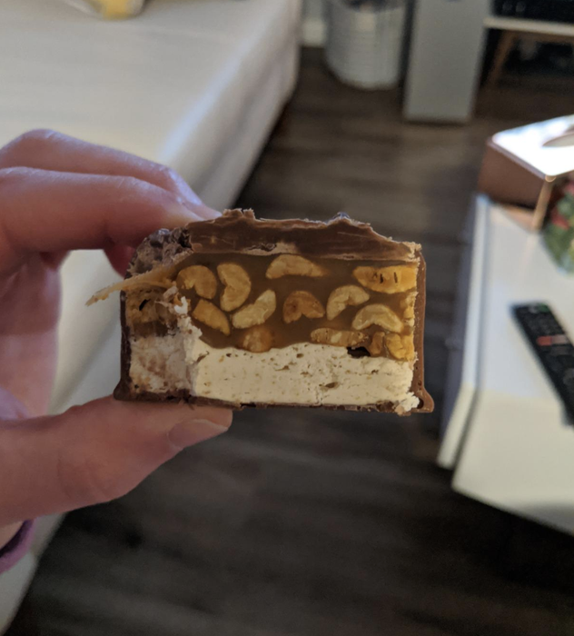 A close-up view of the inside of the enormous Snickers bar, showcasing its delicious layers.