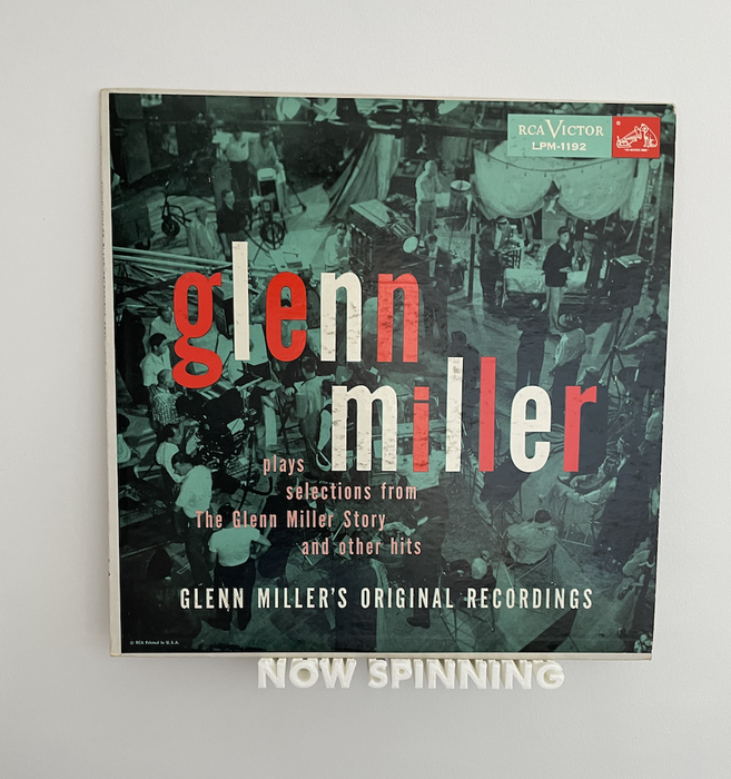 A spinning rack featuring a Glenn Miller vinyl record.